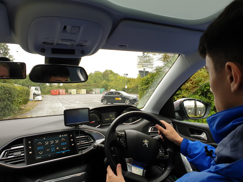 A student steering on the private training road